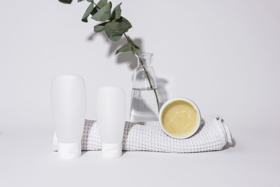 Elegant presentation of bathroom bottles with eucalyptus on a white background
