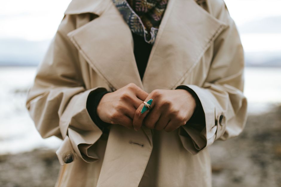 Woman wearing a trench coat and turquoise ring