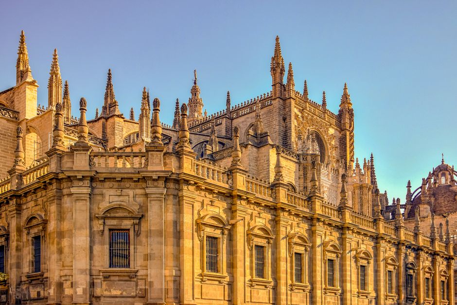 Gothic Seville Cathedral facade in warm sunlight