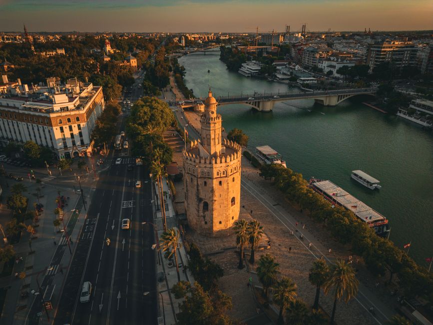 Aerial view of Torre del Oro and Guadalquivir River at sunset in Seville, Spain