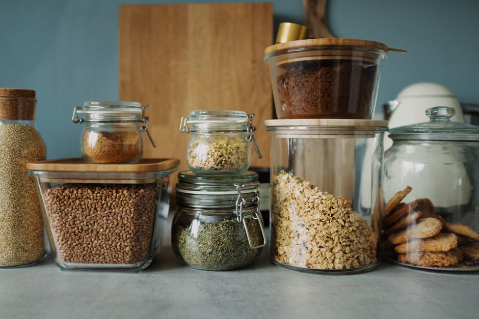 Stylish pantry setup with a variety of foods in glass storage jars