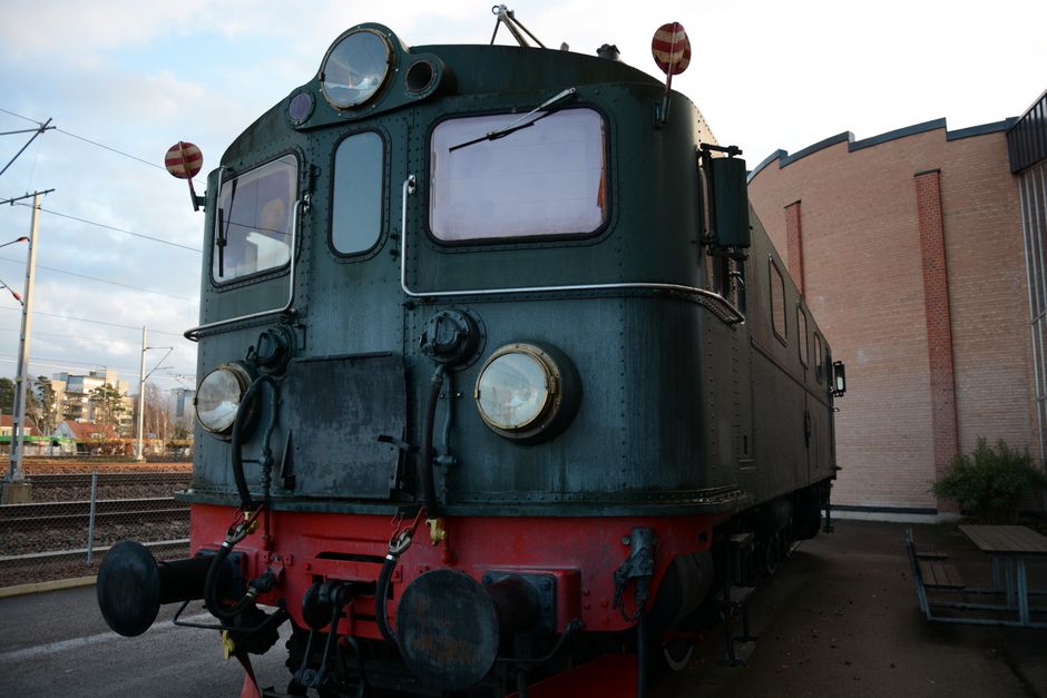Close-up of a vintage locomotive displayed outdoors at a railway museum